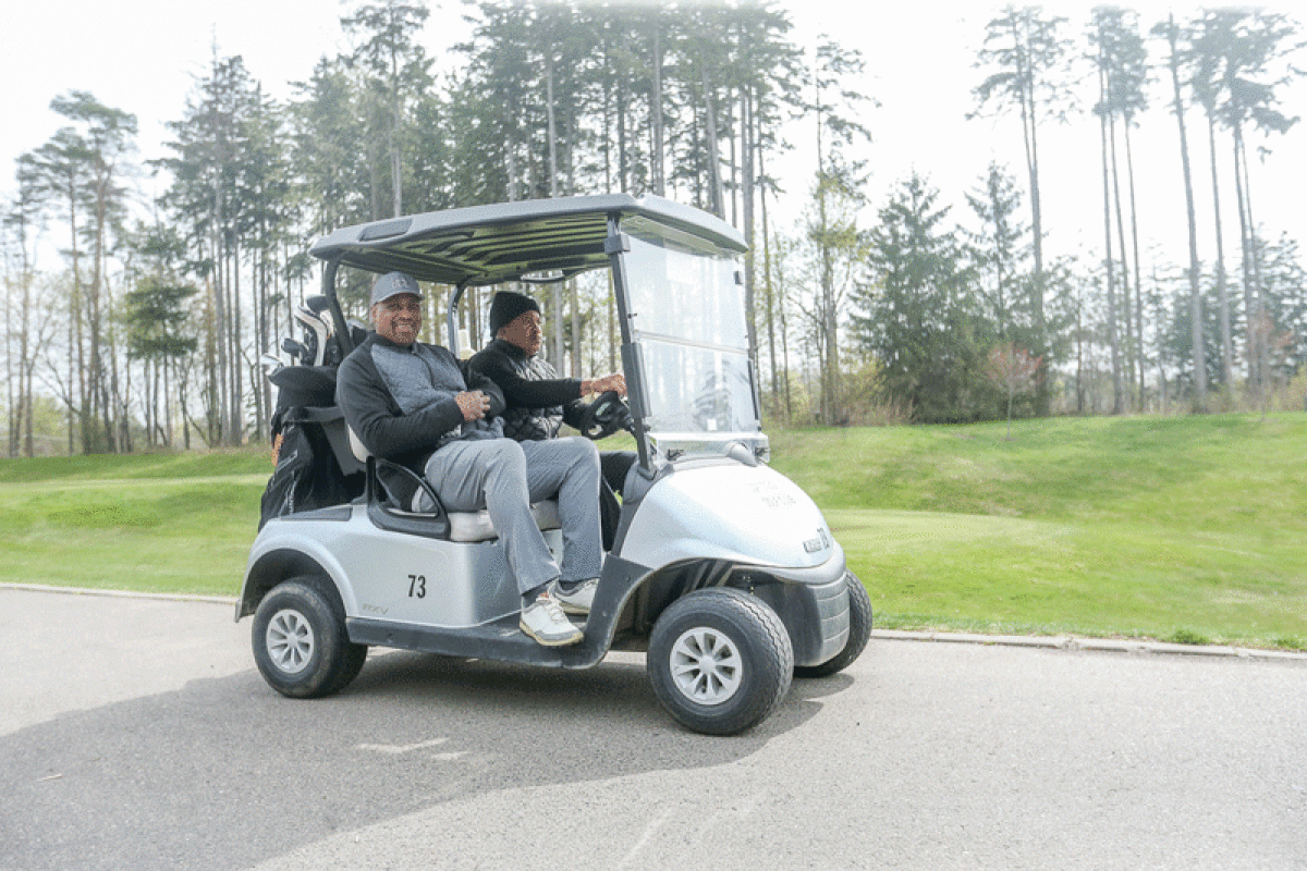  Southfield resident TJ Hemphill, passenger, and West Bloomfield resident Andrae Washington head onto the course after teeing off at the Farmington Hills Golf Club April 20. The club has had a big boom since the onset of COVID. 