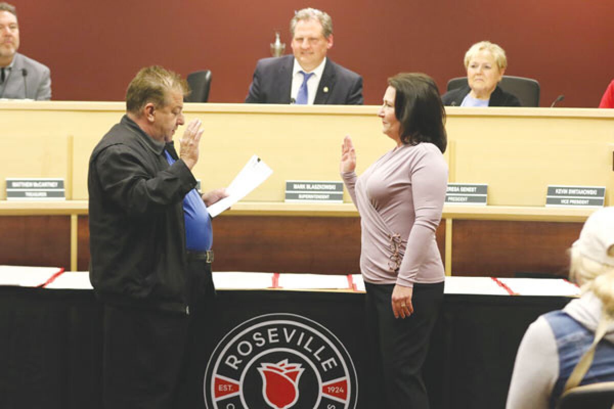  At the April 17 Roseville Community Schools Board Of Education meeting, the school board voted 6-0 to appoint Denise Brun, right, to fill a vacancy on the school board. During the meeting, board Secretary Joseph DeFelice, left, administered the oath of office to the new school board member. 