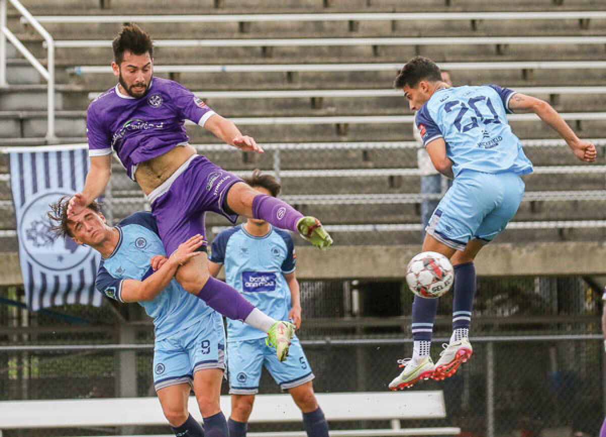  Oakland County FC midfielder Alejandro Steinwascher fights to keep possession in a 5-0 loss to AFC Ann Arbor at Royal Oak High School May 28. 