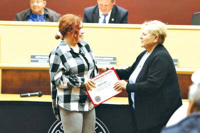  Roseville Community Schools Board of Education President Theresa Genest, right, congratulates Eastland Middle School student Catelyn Lake for her dedication to the student council. 