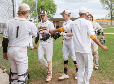  Freshman Ben Dempster greets junior Parker Picot and senior Braedy Limke as they enter the dugout. 