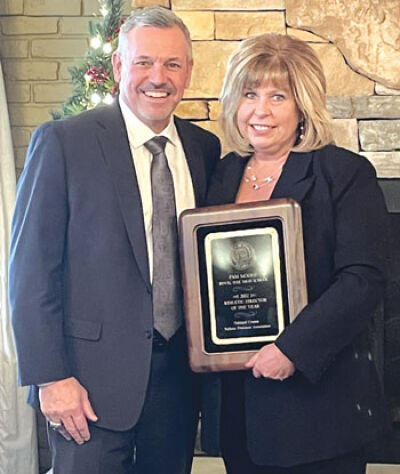  Royal Oak’s Pamela Moore and Brian Gordon celebrate Moore being named Oakland County Athletic Director of the year Dec. 15 at Oakland County’s Holiday Party and Awards Ceremony. Moore recently was named the 2023 Michigan High School Coaches Association Jack Johnson Distinguished Service Award winner. 