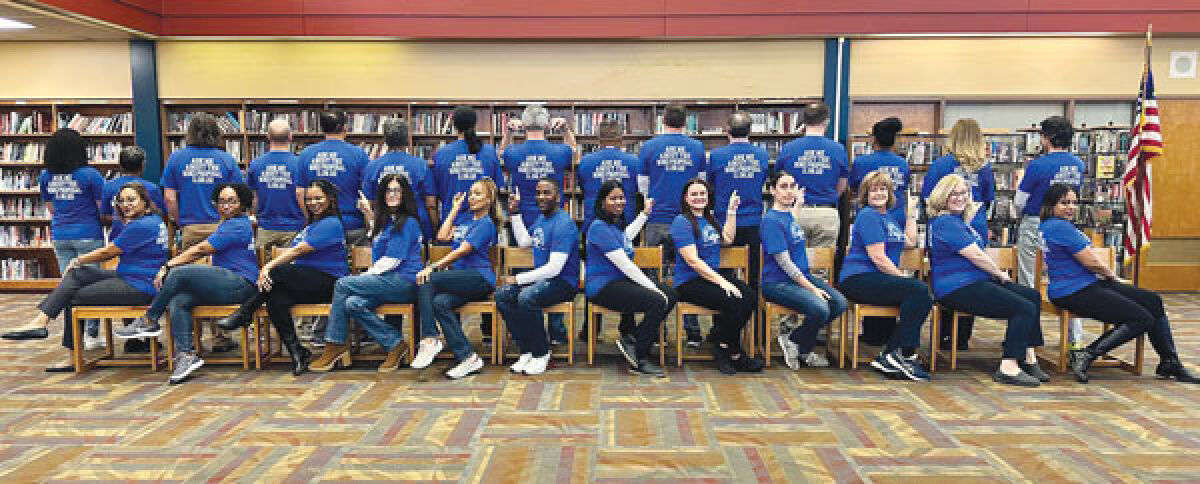  Southfield A&T and UHSA high schoolers and staff pose in “ASK ME ABOUT THE BOND PROPOSAL 11.08.22” shirts. 