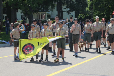  Boy Scout Troop 360, of Rochester Hills, waves to the crowd during the parade. 