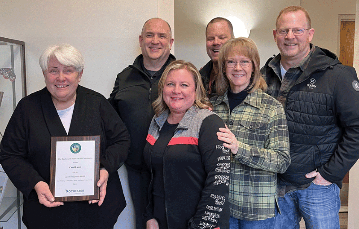  Carol Lamb stands with her neighbors, who nominated her for the city of Rochester Good Neighbor Award. 