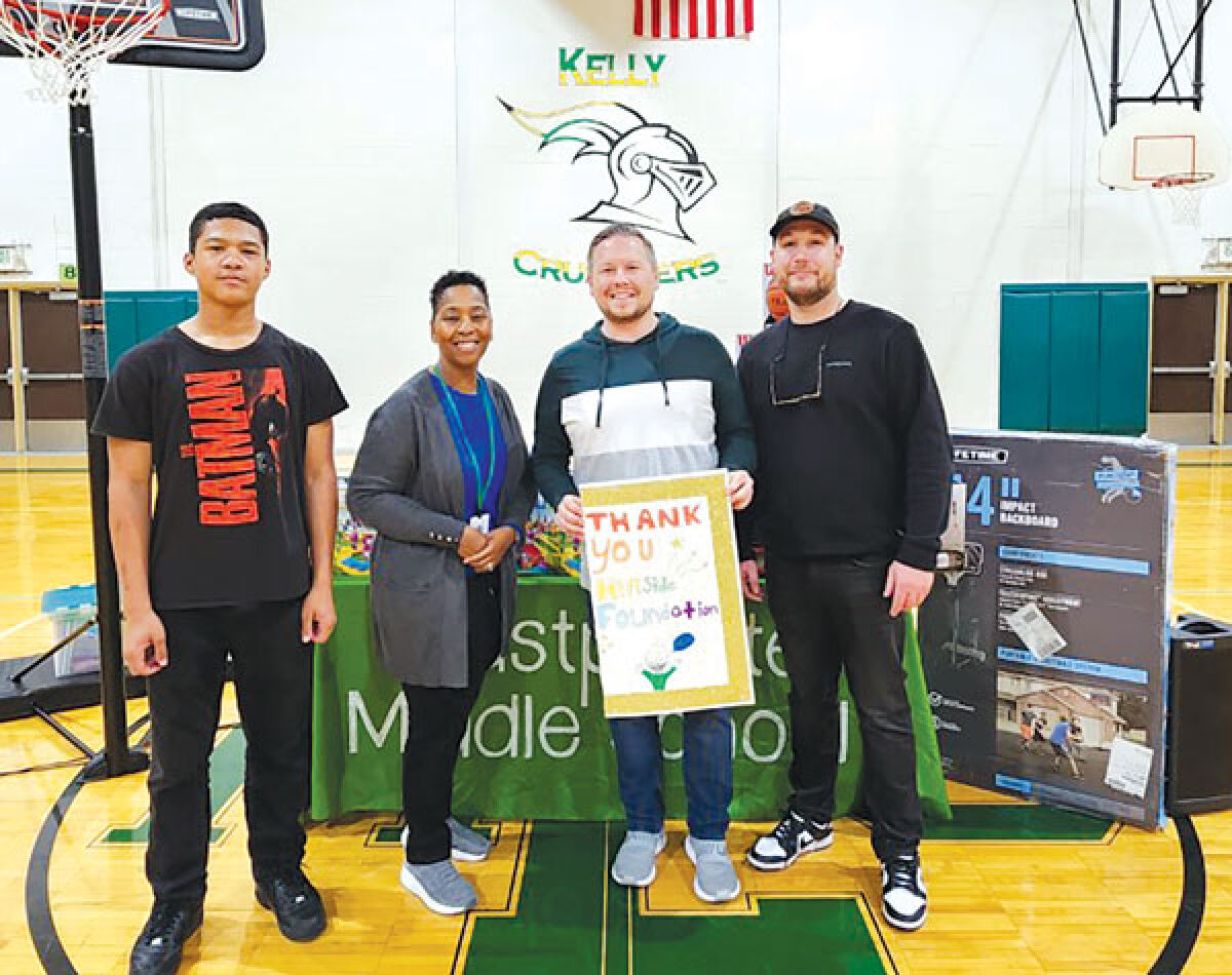  On April 26, Hillside Foundation members Mark Beltz, second from right, and Matt Morisette, right, donated gym equipment and board games to Eastpointe Middle School during a pep rally. Pictured with them are seventh grader Carter Johnson, left, who served as the pep rally’s emcee, and Principal Deniescha Malone, second from left. 