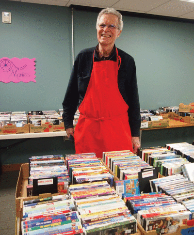  Friends of the Bloomfield Township Public Library volunteer Bob Schnorbus assists at a previous book sale. 