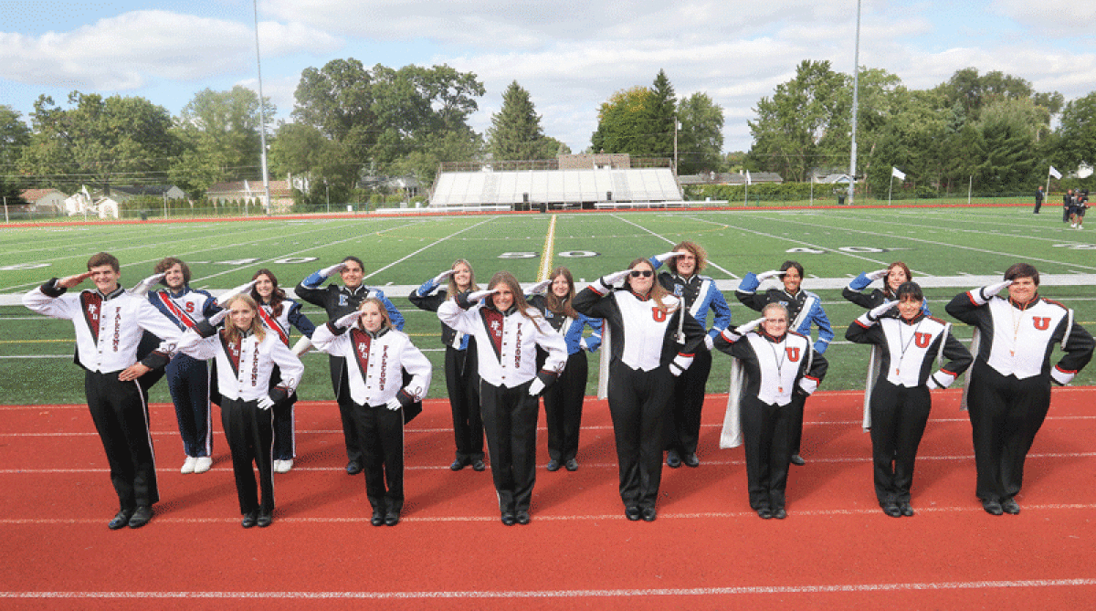  Drum majors James Velasco, Emma Hildebrand, Margaret Johnson and Jenna Burton, of Henry Ford II High School; Maia Suggs, Emma Phillips, Lila Sapiano and Chloe Fashho, of Utica High School; Braden Cook and Chloe Zaharof, of Stevenson High School; and Ethan Delbeke, Cayla Colby, Rosaria Serraiocco, Ian Garden, Divya Bartley and Kenzie Mazzola, of Eisenhower High School pose for a photo last September before the district’s annual Band-A-Rama in October. 