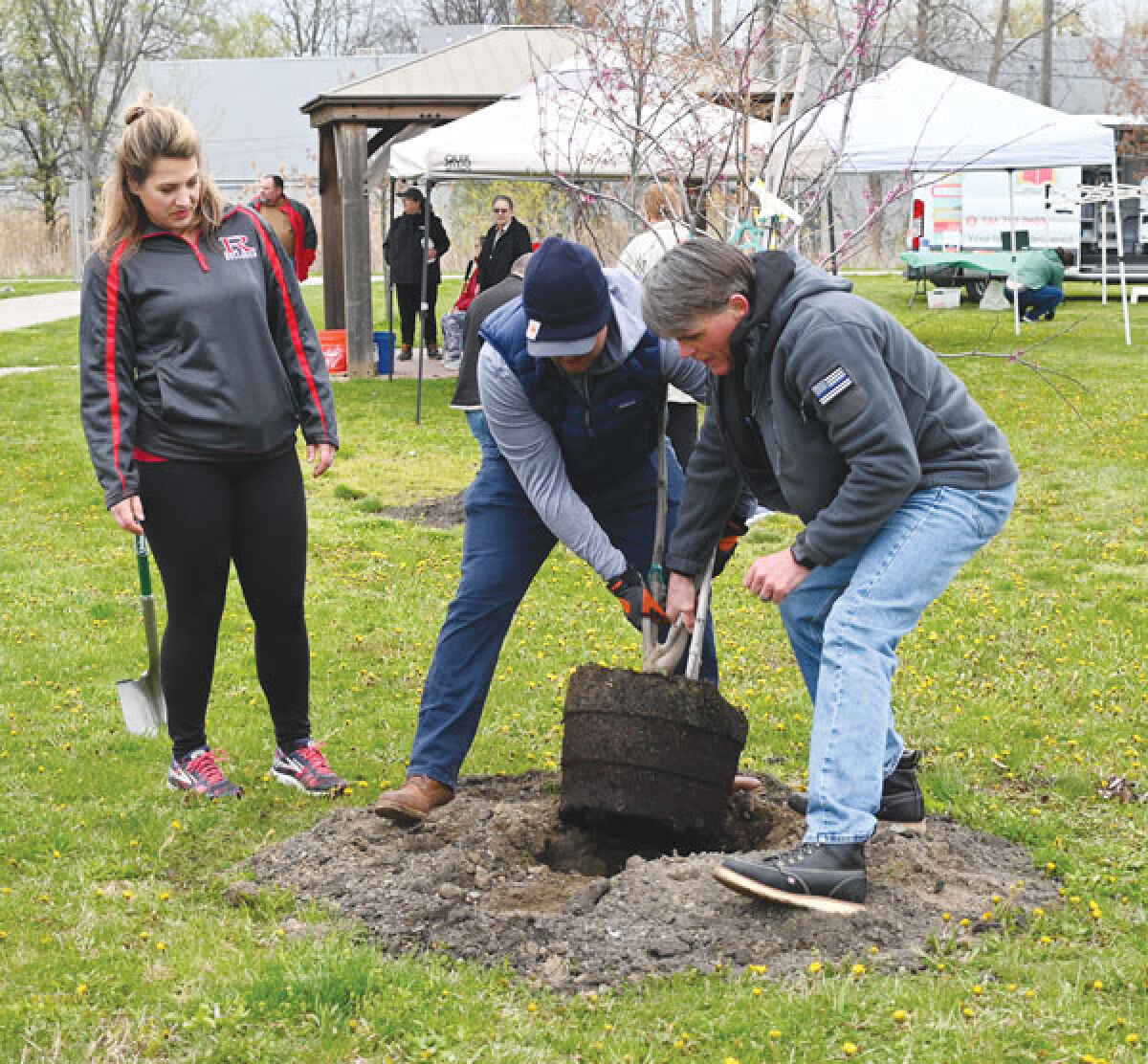  Pictured left to right, Village of Romeo President Meagan Poznanski, Macomb Deputy County Executive John Paul Rea and Macomb County Executive Mark Hackel plant a tree on Arbor Day. 