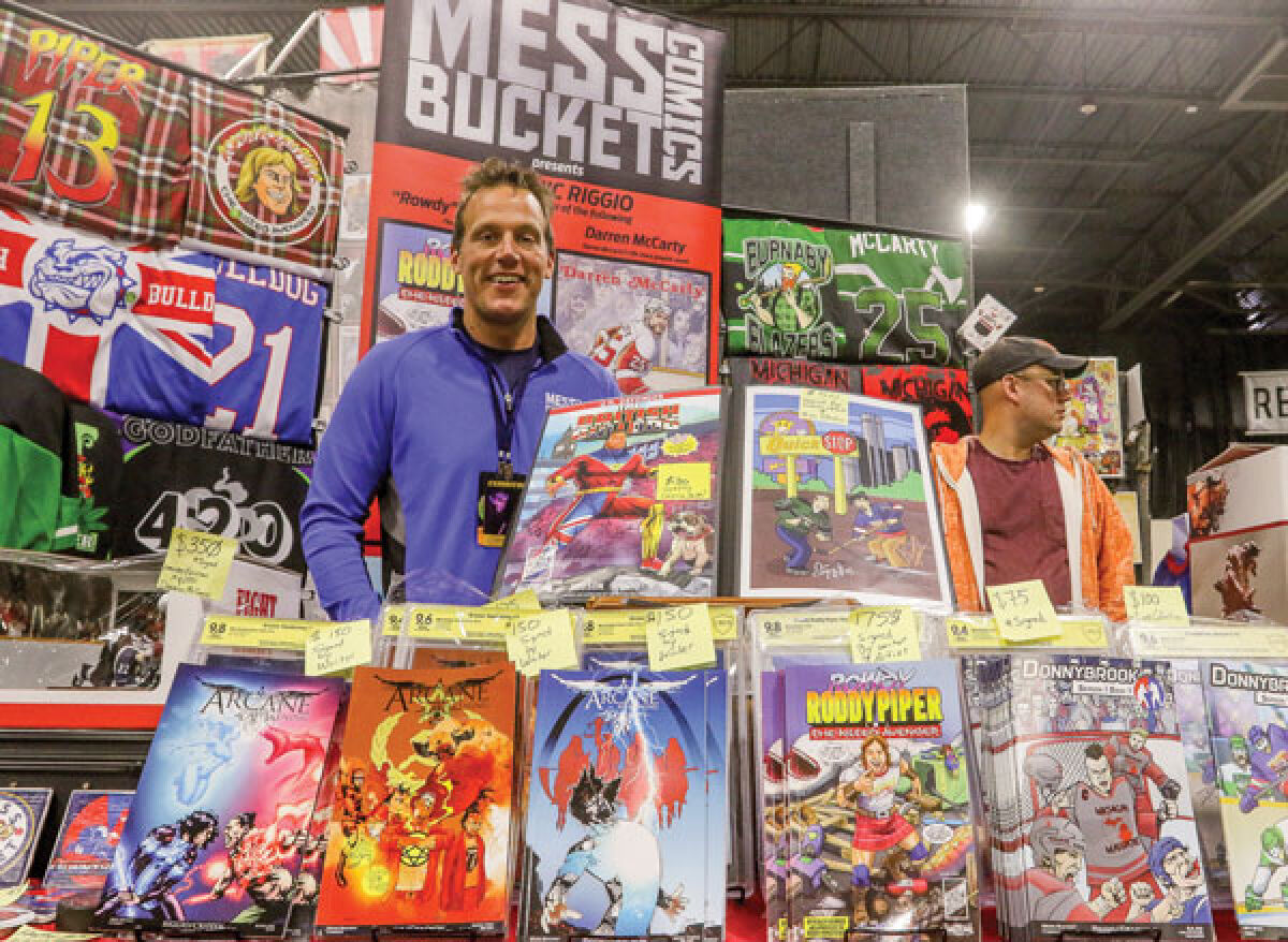  Writer Dominic Riggio, of Birmingham, displays the work he does through his business, Mess Bucket Comics, at Motor City Comic Con last October. One of his comics series is based on his time playing junior hockey, and one of the comics features a story based on his experiences with former Detroit Red Wing Darren McCarty. 
