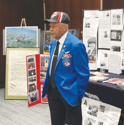   Bill Welborne, a retired chief master sergeant who was a member of the famed Tuskegee Airmen, addresses the Pettipointe Questers #243 May 4 at the  Ewald Branch of the Grosse Pointe Public Library in Grosse Pointe Park. Welborne’s presentation on the history of the Tuskegee Airmen included a display of books, photos and multiple posters. He has traveled around the country  sharing stories about this military outfit. 