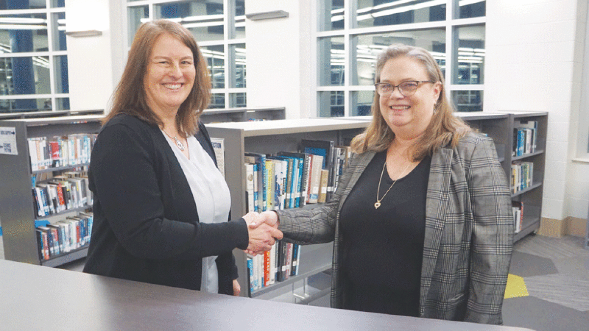  Board President Michelle Bueltel congratulates Julie Alspach on her appointment to the Rochester Community School District Board of Education. 