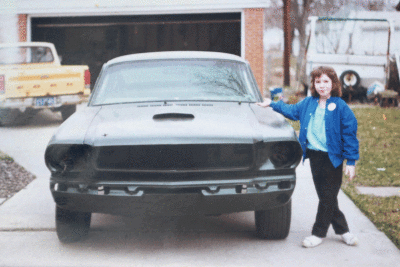   Danielle (Waggoner) Watts is about 8 years old in this photo, standing by the Ford Mustang before it was restored. She was often by her dad’s side when he worked on the car 