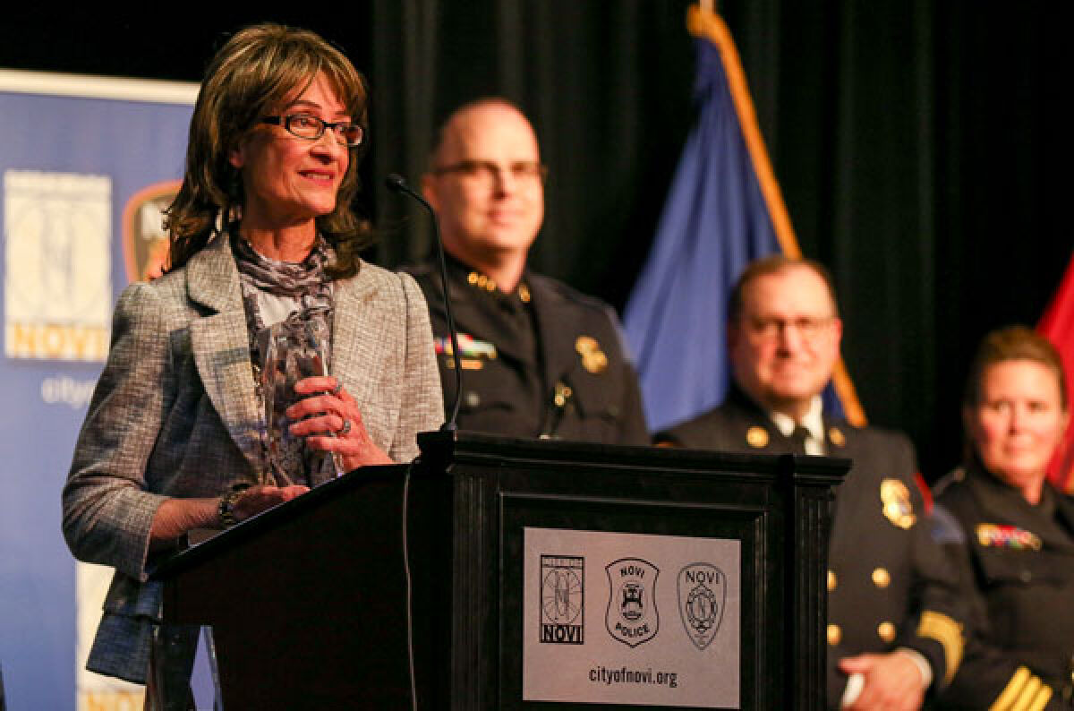  Volunteer of the Year Lori Karlow expresses her gratitude after Novi Police Chief Erick Zinser presented her with the honor during the May 4 Police and Fire Awards Ceremony at the Novi Civic Center. 