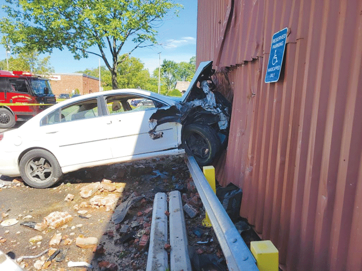  A speeding Saturn Aura went airborne and ended up embedded in the side of the U.S. Post Office building on Mack Avenue in Grosse Pointe Farms the morning of July 9, sending bricks and other building debris flying. 