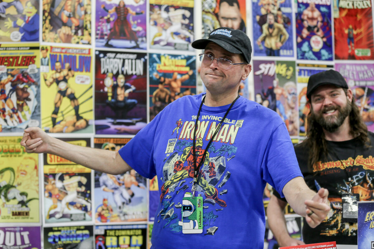  Erik Hodson, of Grosse Pointe, shows his illustrations at Motor City Comic Con in Novi May 19. With Hodson is his agent, Dan Carr, of Grosse Pointe Farms. 