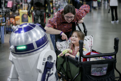  Caitlin Bridges and her daughter, Aayla, 4, of Oak Park, enjoy visiting with R2-D2 from “Star Wars.”  