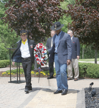  Shelby Township Veterans Events Coordinator Phil Randazzo and John James, a veteran who was elected to the U.S. House of Representatives last year, place a wreath during Shelby Township’s Memorial Day ceremony last year. 