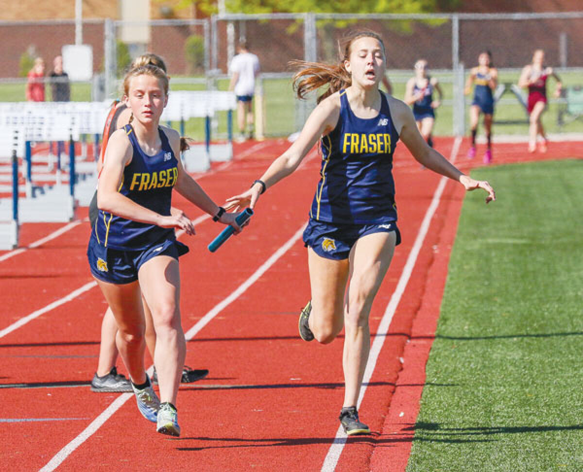  Fraser junior Remi Flanz hands off to freshman Katelyn Frazier during the team’s 4x800 relay at the MAC White meet on May 15 at Fraser High School. 