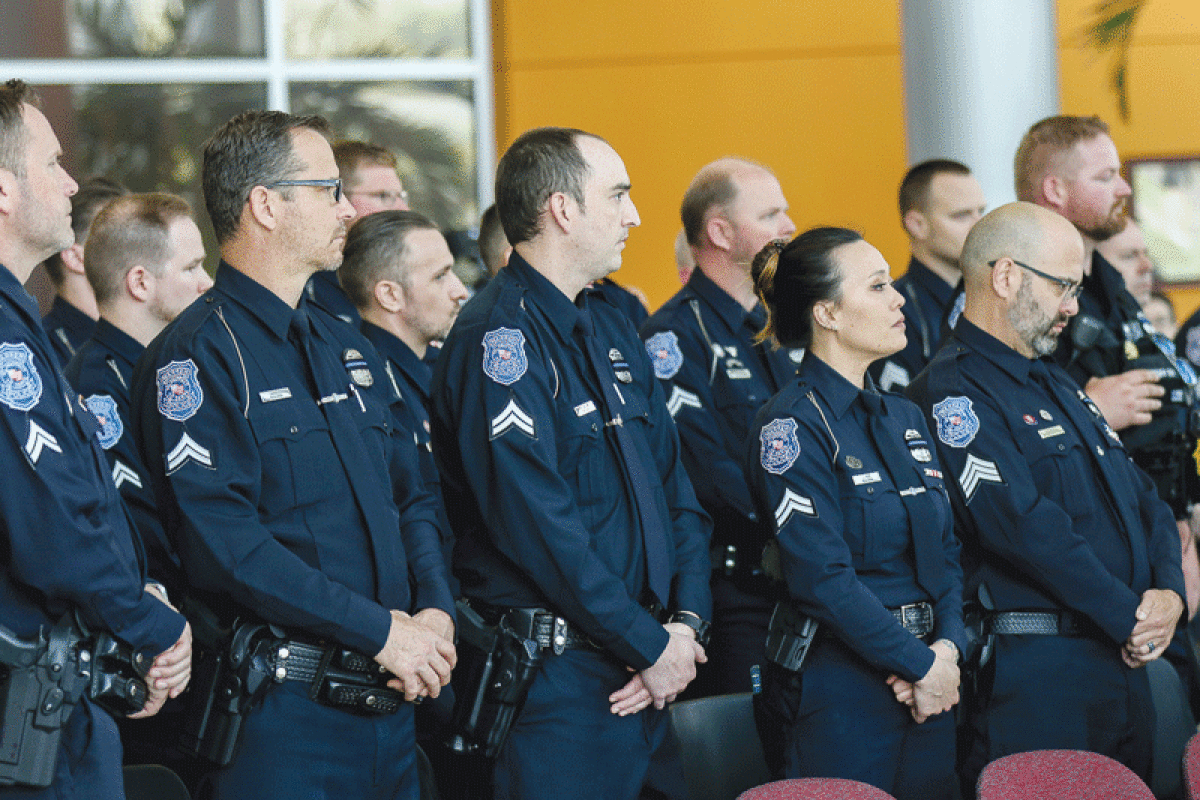  Officers observe the ceremony honoring their fallen comrades. 