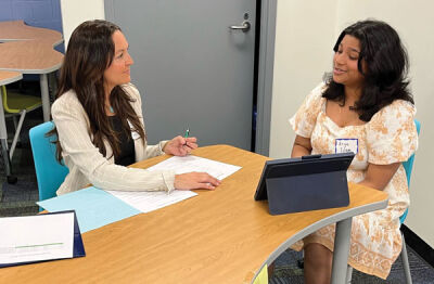  Deneen Macedonia, a business development consultant at Trion Solutions in Troy, gives Larson Middle School eighth grader Arya Islam a mock interview as part of the district’s annual interview preparation program. 