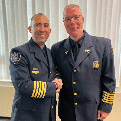  Retiring Bloomfield Township Police Chief Phil Langmeyer congratulates new police chief James Gallagher on his promotion. 