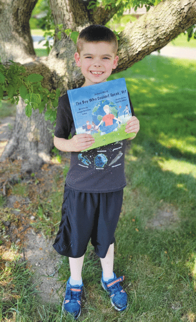  Jack Geyer holds Jordan  Christian LeVan’s book, “The Boy Who Couldn’t Speak, Yet,” which is Jack’s favorite book. 