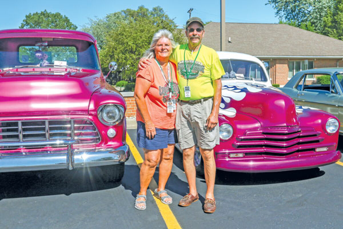  Organizers Kim Barich and Jim Mischel pose for a photograph at last year’s Cruisin’ Gratiot car show at First State Bank. 