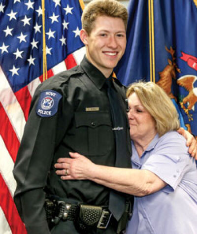 Officer Justin Petrill gets a hug from his aunt, Vicki Azzopardi, after being sworn in. 