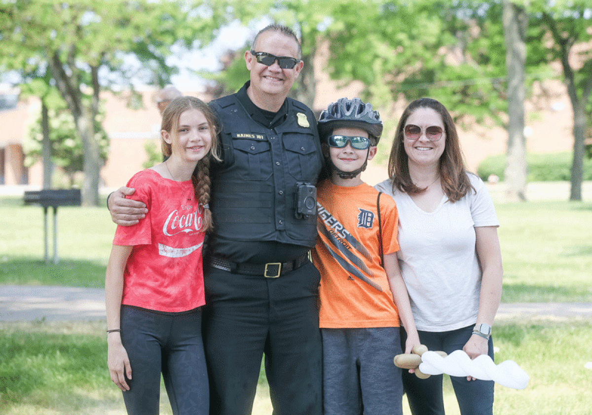  Corey Haines shares a moment with his daughter Hannah, 14, son Logan, 11, and wife Heather during the annual Bike Rodeo on June 10.  