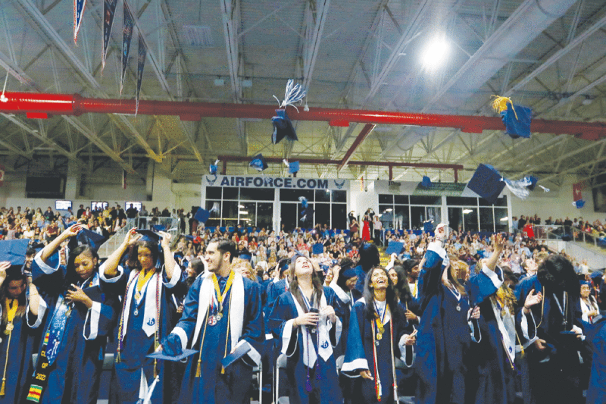   Farmington HIgh School graduates celebrate the end of their high school career with the  traditional cap toss following a ceremony at the USA Hockey Arena in Plymouth June 11.  
