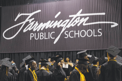   Members of the 2023 North Farmington High School graduating class file into the USA Hockey Arena in Plymouth for their commencement ceremony June 11.  
