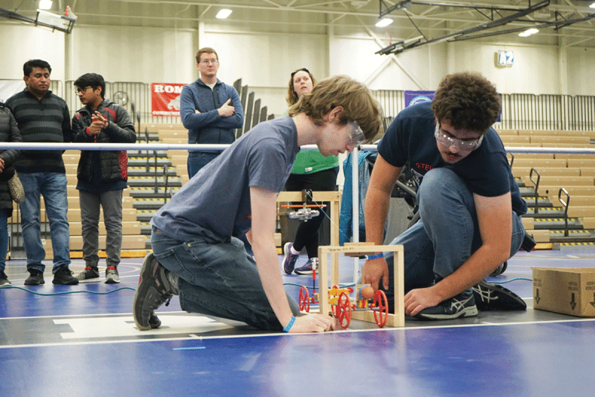  Two students compete in a Science Olympiad event. 