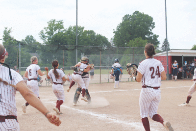  The Utica Ford II softball team celebrates a win over Warren Regina 5-2 on June 10 to claim the Michigan High School Athletic Association Division 1 Region 7 championship at Troy Athens High School. 