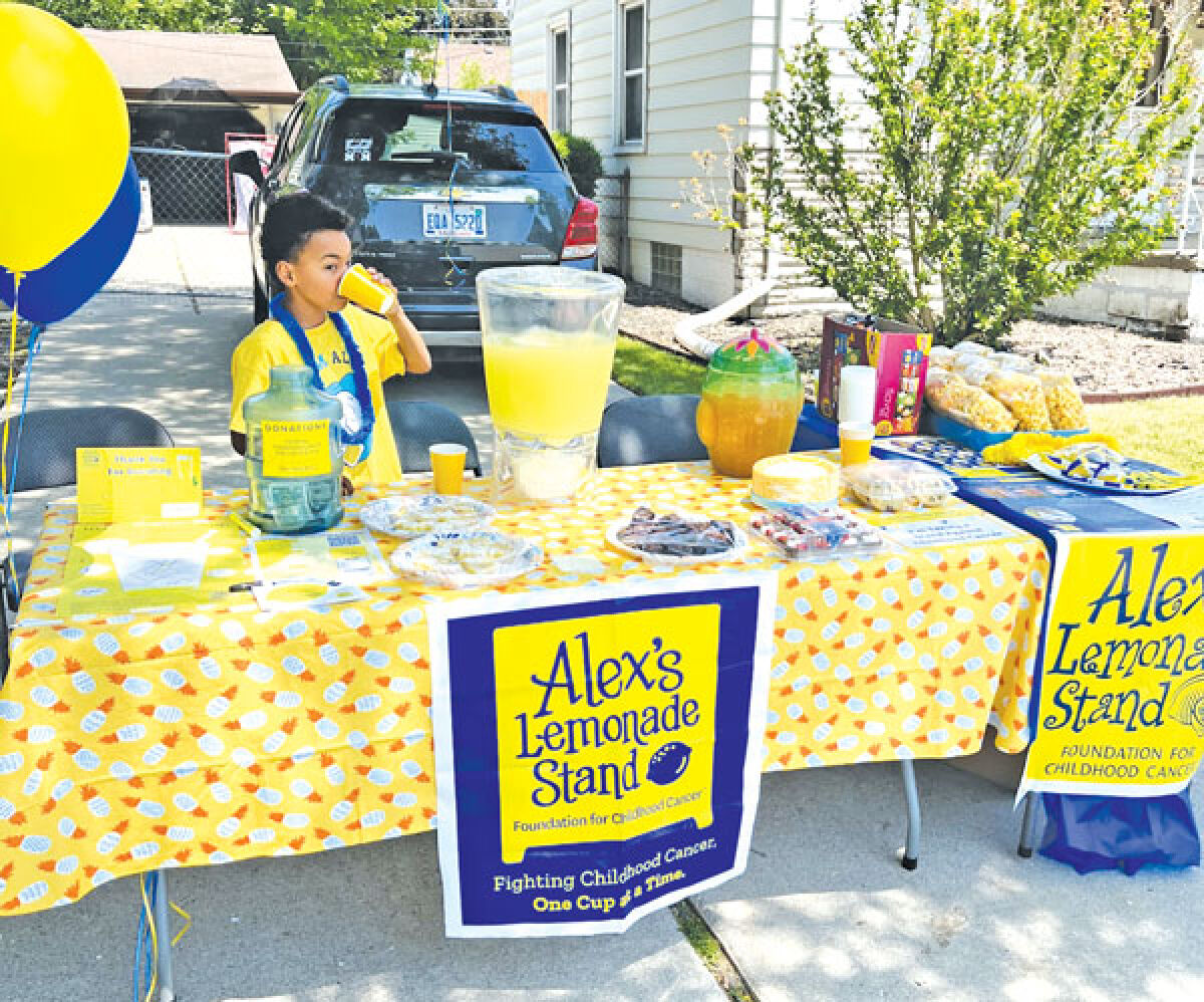  William Stogiera stands at his lemonade stand, ready to serve refreshments and earn money for charity. 
