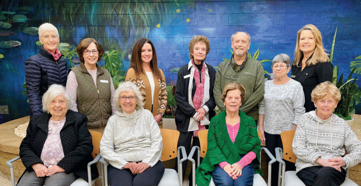  The Older Persons’ Commission’s Adult Day Service staff and clients gather in the atrium  of the center. 
