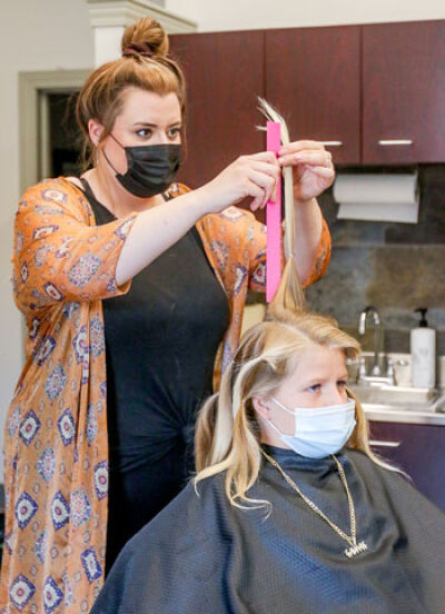  On June 29, hairstylist Sara Pietrykowski cut off Trey Irvin’s long locks to be made into a wig at Maggie’s Wigs 4 Kids of Michigan in St. Clair Shores. 