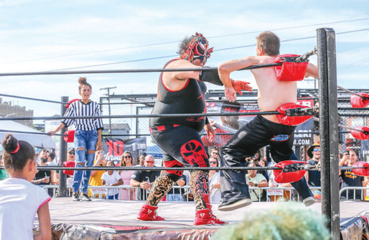  Wrestlers showcase the lucha libre style of the sport at last year’s Royal Oak Taco Fest. Lucha libre will return for this year’s Taco Fest. 