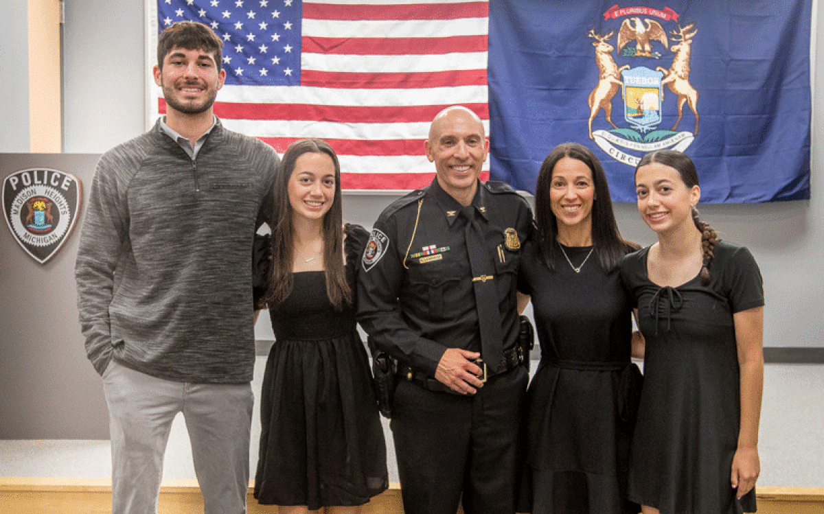  Brent LeMerise, the new police chief in Madison Heights, center, stands with his son, Austin, and daughter, Brianna, left, and wife, Alicia, and daughter, Brooklyn, right. He was sworn in at the Madison Heights Police Department June 29.  