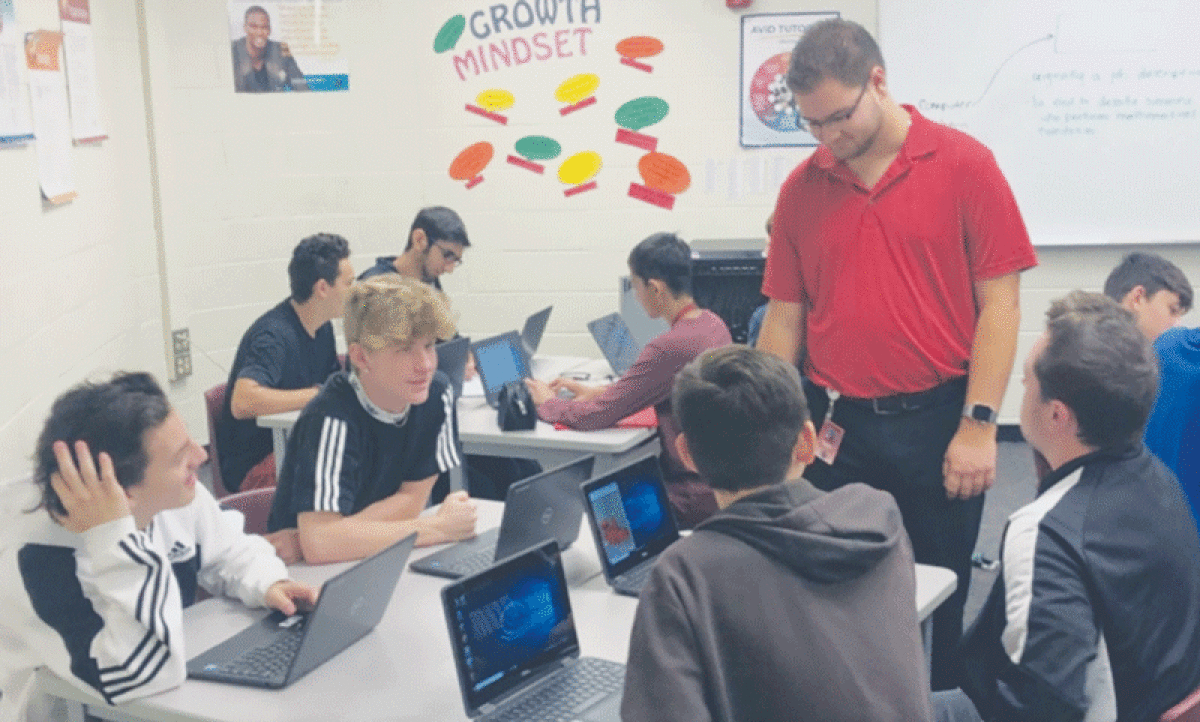  Doug Hartley, who is now a Utica Community Schools teacher, seen here in a Henry Ford II High School computer science classroom, was one of the first volunteers in the Technology Education and Literacy in Schools program. Utica Community Schools is looking for more IT professionals to join the program and support classroom instruction. 