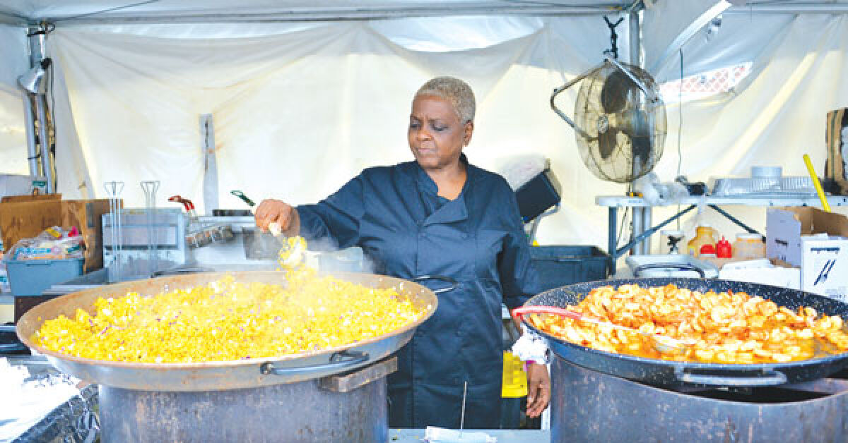  Gina Evans, of Ke’Niya’s Kitchen, stirs up some cilantro rice at Royal Oak Taco Fest July 3. 