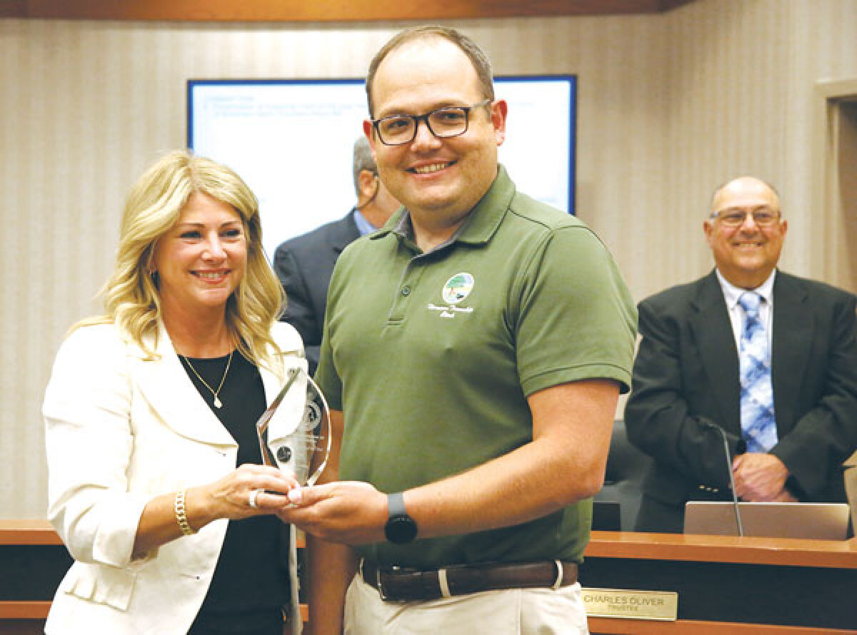  Macomb Township Clerk Krisit Pozzi, left, stands with Adam Wit, the immediate past president of the Michigan Association of Municipal Clerks and the current Harrison Township clerk. Pozzi was presented with the association’s 2023 Township Clerk of the Year award at the June 28 Macomb Township Board of Trustees meeting. 