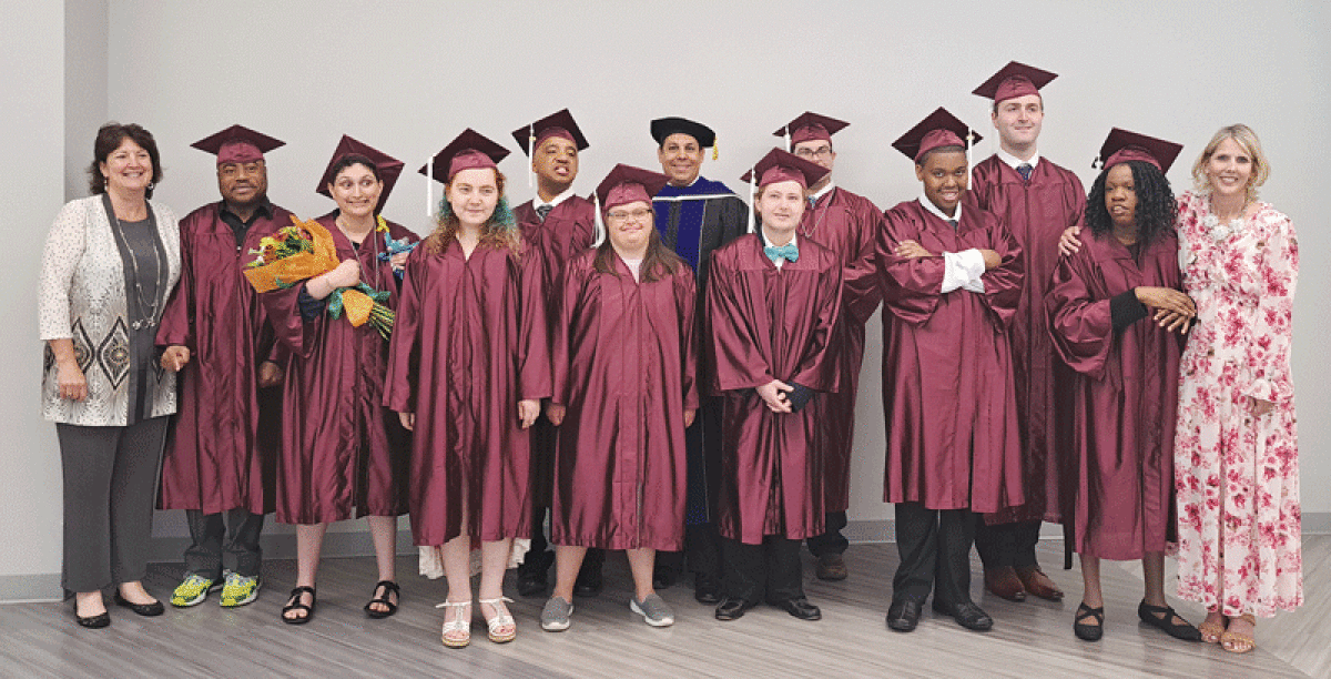  All 10 of the 2023 graduates of the Visions Unlimited program pose with principal Dorene Forster, left; Superintendent Christopher Delgado, center; and teacher Colleen Hrischuk, right, following graduation.  
