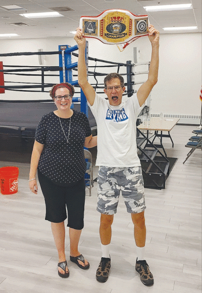  Gary Richard hoists his Midwest Masters Boxing Tournament title belt alongside his daughter, Emily Kot, after earning a decision victory on July 16 in Ann Arbor. 
