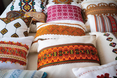  Pillows embroidered with different Ukrainian  styles by Papiz are arranged on a bed in her Warren home. 