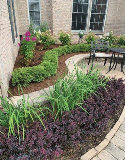  Fresh mulch, plants free of dead leaves and stems, and bright flowers enhance the appearance  of the home. 