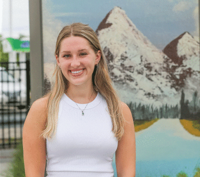  Berkley High School 2022  graduate Ellie Kubicki stands by her work in the ArtSpace plaza during the plaza’s grand opening July 15. 