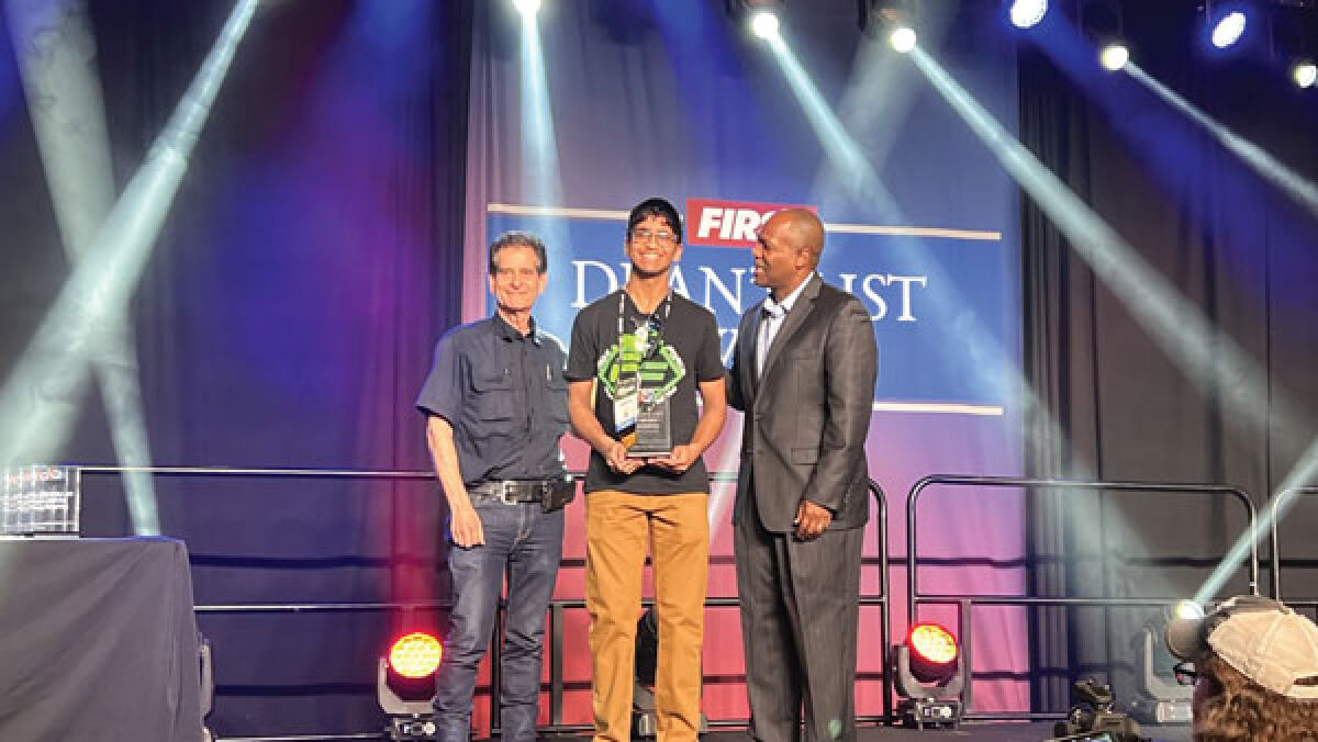  Sanjith Udupa, of Novi, poses for a picture with Dean Kamen, left, the founder of FIRST, and Chris Moore, FIRST’s CEO, after being named a Dean’s List Award recipient. 