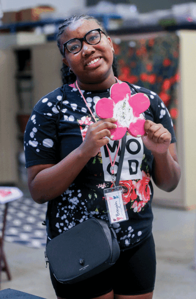  Building Bridges student Breyah Reed created a glitter flower when making her melted crayon project.  
