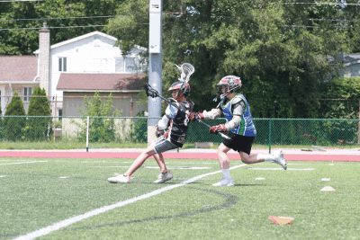   Two camp attendees go head-to-head in an attacker-versus-defender drill as the attacker attempts to score. 